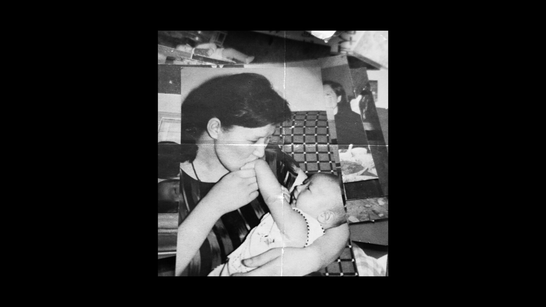 A black-and-white photograph of a parent holding a baby